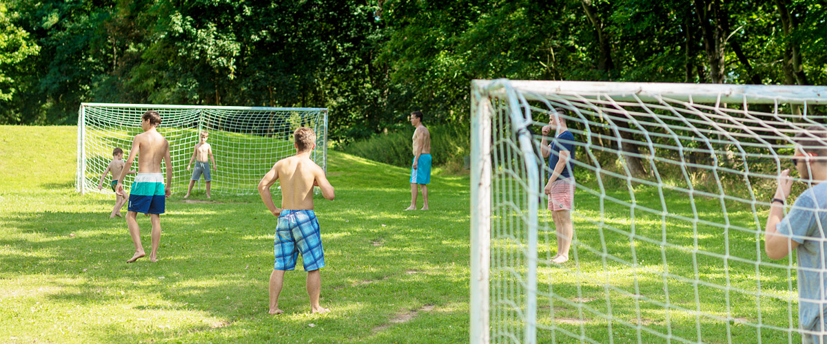 sportovní koupající se hrající fotbal na trávníku