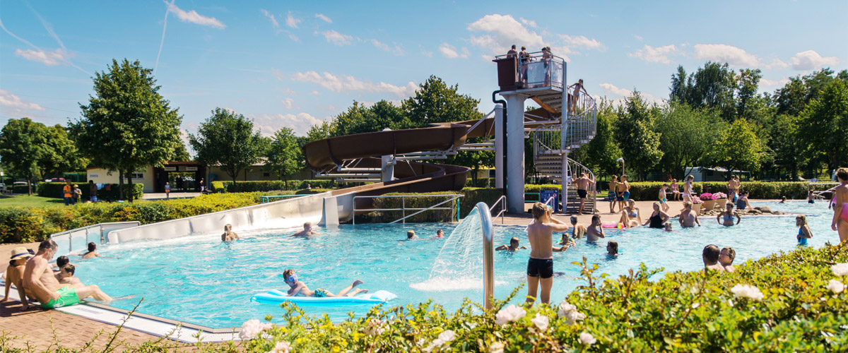 lively adventure pool with giant slide and waterfall shower