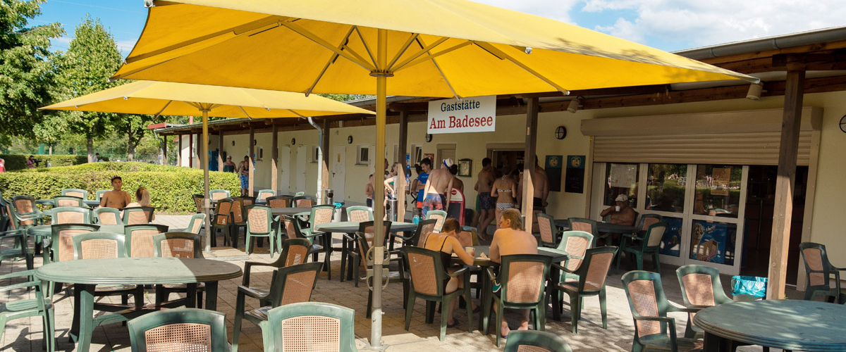 Outdoor area of the restaurant with parasols and seating, towards the outdoor pool.